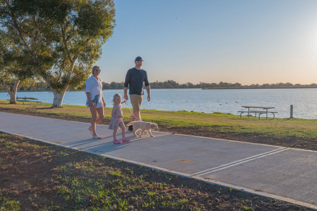 family walking along Gum Bend lake